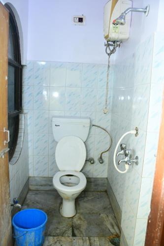 a bathroom with a toilet and a shower at Hotel Sampark in Bhadrak