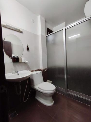 a bathroom with a toilet and a shower and a sink at The Cloud Hotel in Da Lat