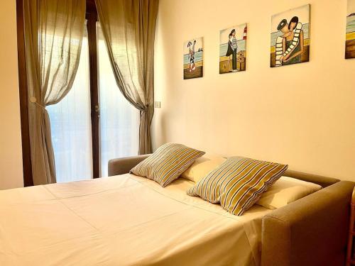 a bed with two pillows on it in a bedroom at Grado Dolce Vita beachfront in Grado