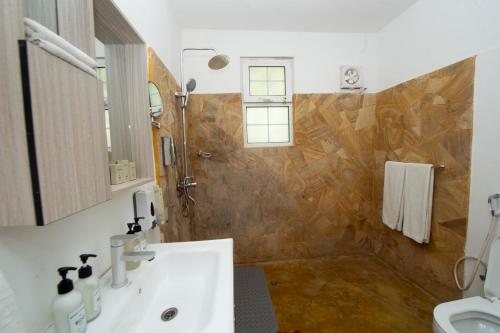 a bathroom with a sink and a shower at Double A Nungwi Beach Hotel - Beach Front in Nungwi
