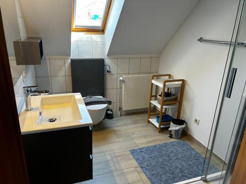 a bathroom with a sink and a toilet at Ferienhaus Seenelke in Neßmersiel