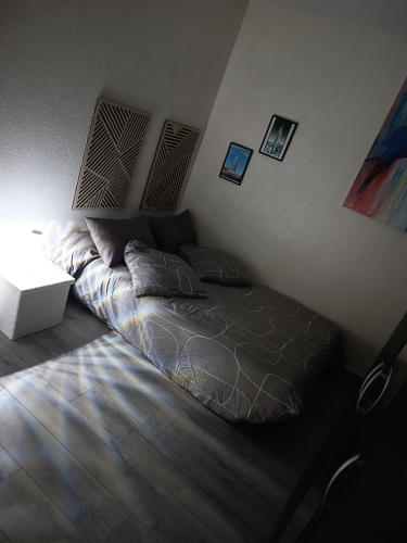a bedroom with a bed and a table and a lamp at Chambre double avec lit clic clac in Saint-Pardoux-Isaac