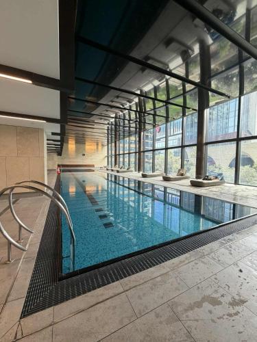 a large indoor swimming pool in a building at The Quarter Elite 1BR Resort-Style Amenities in Melbourne