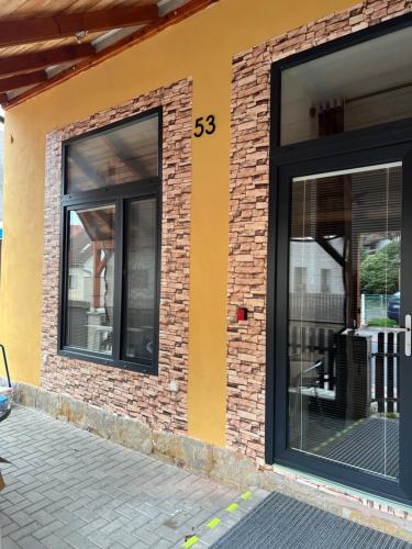 a building with two windows on the side of it at UbytkoMácháč in Staré Splavy