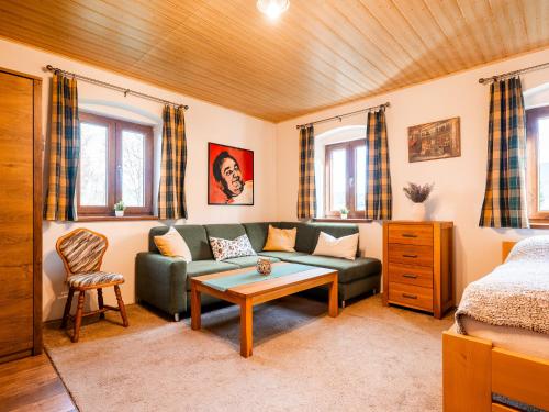 a living room with a couch and a table at Chalupa Sibřinka in Korkusova Huť