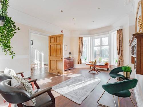 a living room with chairs and a table at Spacious Buxton house with hot tub and pool table in Norwich