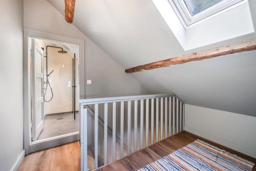 a room with a staircase and a skylight at Kongshamn Gjestgiveri in Kirkehamn