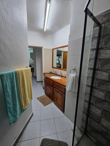 a bathroom with a sink and a mirror at Le Rocher De Machabee in Mahe