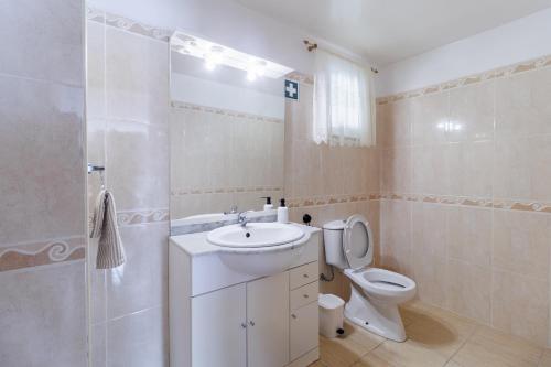 a bathroom with a sink and a toilet and a shower at Santana Lens & Trail House in Santana