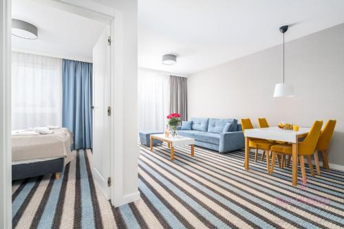 a hotel room with a bed and a table at Your Holidays Bel Mare II D105 in Międzyzdroje