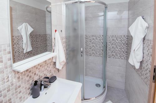 a bathroom with a shower and a sink at Apartmani AE in Biograd na Moru