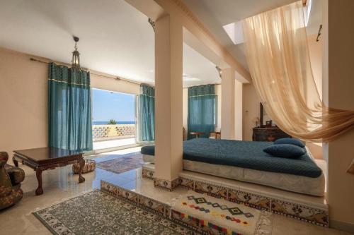 a bedroom with a bed and a large window at Maroccana in Dobra Voda