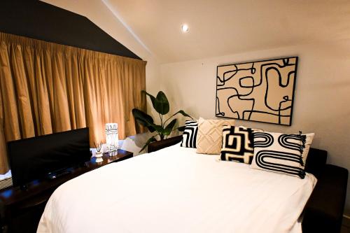 a bedroom with a bed and a desk with a television at Starr Place in Liverpool