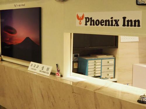 a photograph of a photography firm sign in a store window at Phoenix Inn in Tokyo