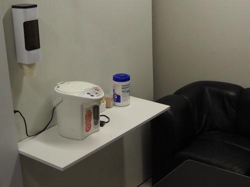 a white table with a sewing machine and a chair at Phoenix Inn in Tokyo