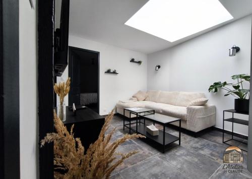 a living room with a couch and a table at L'Atelier de Claude in Wattwiller