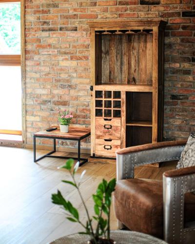 a living room with a brick wall and a table at Janowe Wzgórze in Cieszyna