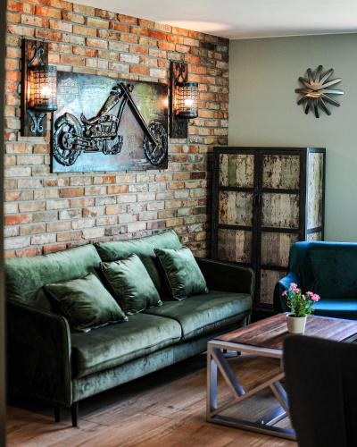 a living room with a couch and a brick wall at Janowe Wzgórze in Cieszyna