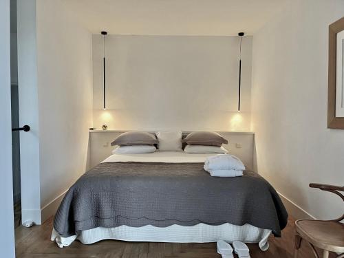a bedroom with a large bed with two pillows at De Hoffstee in Minnertsga
