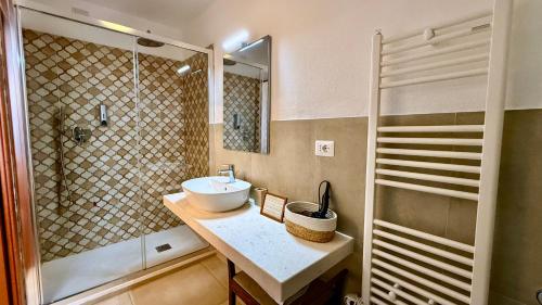 a bathroom with a sink and a shower at Locanda dei Buoni e Cattivi in Cagliari