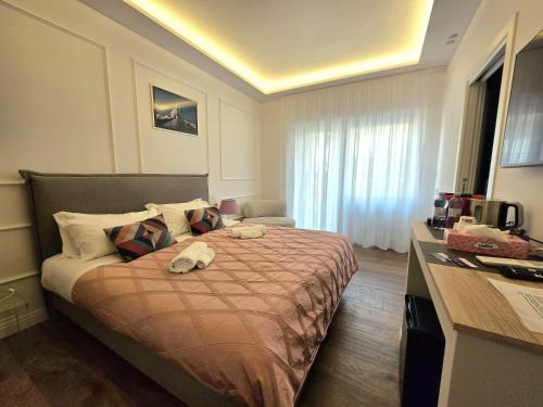 a hotel room with a bed with towels on it at Riviera Suites - by Be Your Home in Civitavecchia