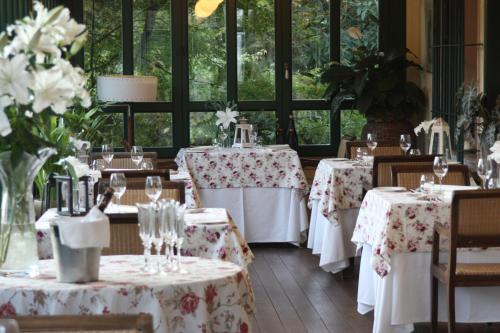 a dining room with tables with white tablecloths at Boutique Hotel Dobra Vila Bovec in Bovec