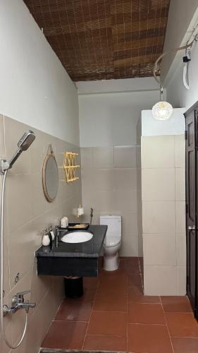 a bathroom with a sink and a toilet at Nos Vetra Resort in Phú Quốc