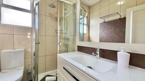 a bathroom with a sink and a shower at The Gray House in Bicas