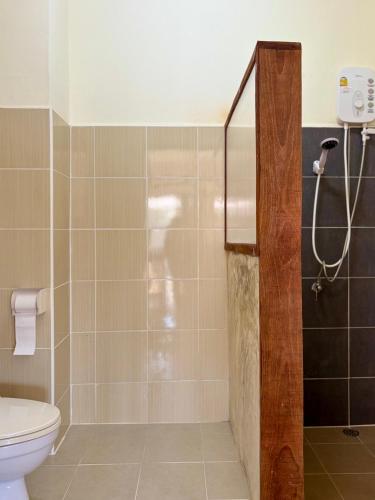 a bathroom with a shower and a toilet at Pai Local Apartment in Pai