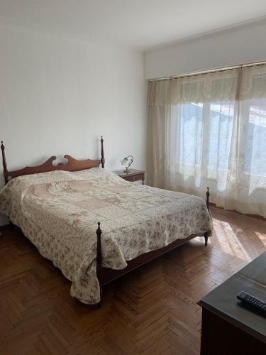 a bedroom with a bed and a desk and window at Casa en Miramar in Miramar