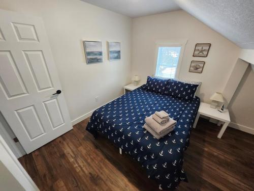 a bedroom with a bed with a blue comforter at Getaway by the bay in Owen Sound