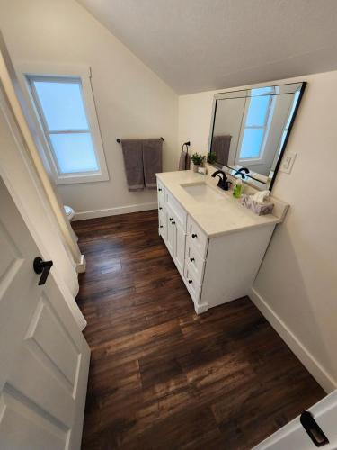 a bathroom with a sink and a mirror at Getaway by the bay in Owen Sound