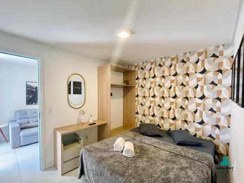a bedroom with a bed and a wooden wall at Aquarius Style by Holiday Stays in Fortaleza