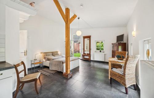 a bedroom with a bed and a table and chairs at Beautiful Apartment In Wingst in Wingst