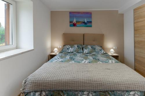 a bedroom with a bed with two night stands at House Cerovac in Nedeščina
