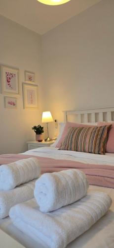a bedroom with two beds with white towels on them at Thalassa in Perdika