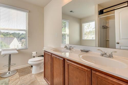 a bathroom with a sink and a toilet and a mirror at Guest House Haven with Gazebo in Riverdale