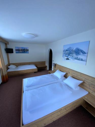 a bedroom with two beds and a blue light at Strubwirt in Waidring