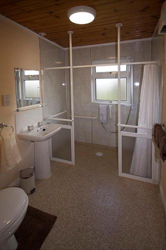 a bathroom with a toilet and a sink at Correay Cottage in Salen