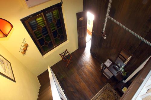 an overhead view of a hallway of a home with a staircase at ke-lan-tan House in George Town