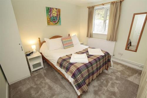 a bedroom with a bed with two towels on it at 1 Bed in Langland oc-hh147 in Newton