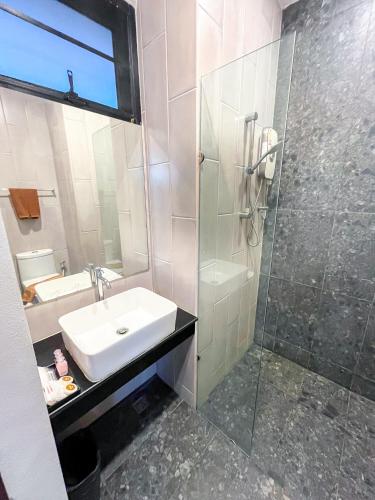 a bathroom with a sink and a shower at Leamsai Beach Resort in Suratthani