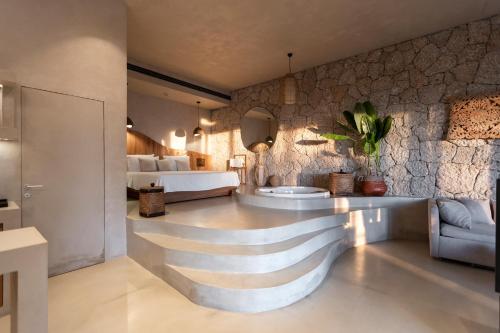 a bathroom with a sink in a room with a bed at Empire Beach Resort ADULTS ONLY in Dhërmi