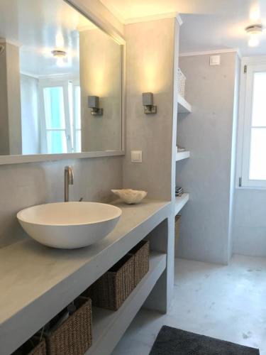 a bathroom with a sink and a mirror at The White House 1 in Andros