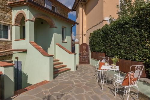a patio with chairs and a table in front of a house at Il Nido 2&2 in Staggiano