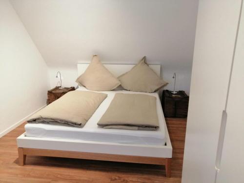a bed with two pillows on it in a room at Weingut Stefan Meyer in Rhodt unter Rietburg