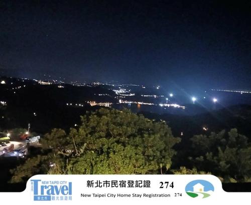 a view of a city at night with lights at Jiufen Let's go Bed and Breakfast in Jiufen