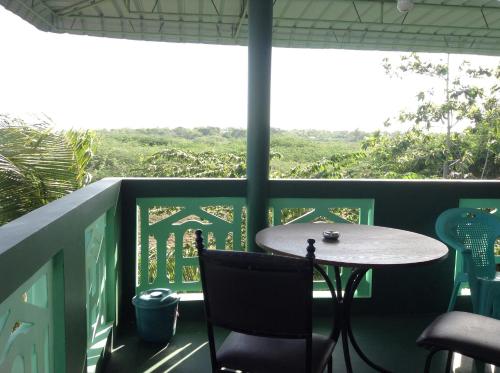 a table and chairs on a balcony with a view at Lagoon Inn in Hambantota