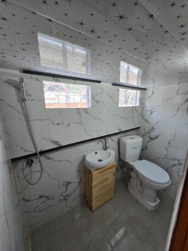 a white bathroom with a toilet and a sink at YourTourKey Gulet Accommodation in Güvercin Adası