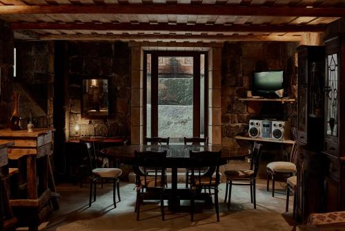 a dining room with a table and chairs and a window at Villa Kars in Gyumri